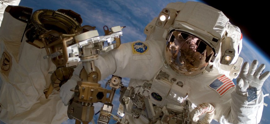 American astronaut Clay Anderson waving during a spacewalk outside the International Space Station. 