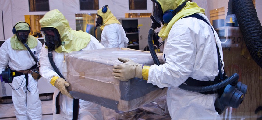 Los Alamos National Laboratory technicians repackage nuclear waste in 2011 for shipment to the Waste Isolation Pilot Plant in New Mexico in 2011. 