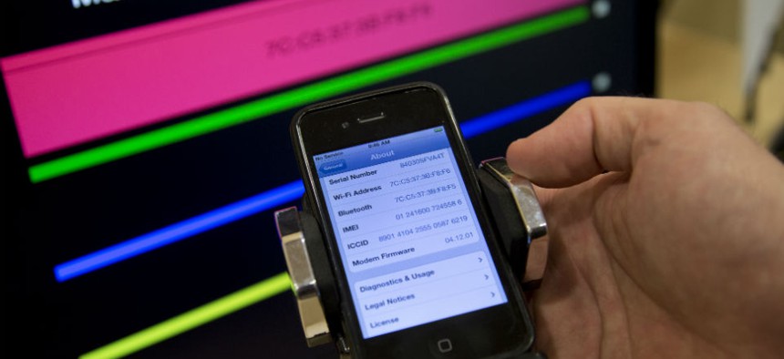 A cell phone displays information during a Federal Trade Commission mobile tracking demonstration.