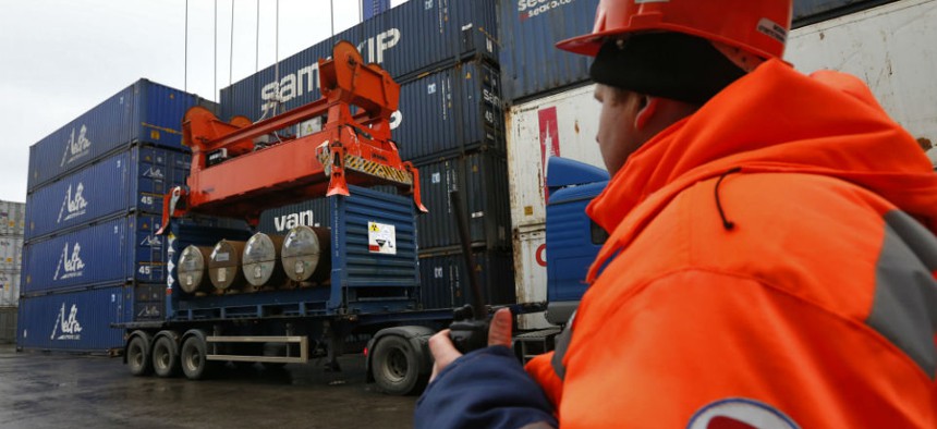 A crane picks up containers with uranium to be used as fuel for nuclear reactors to load them aboard the Atlantic Navigator ship, on a port in St. Petersburg, Russia.