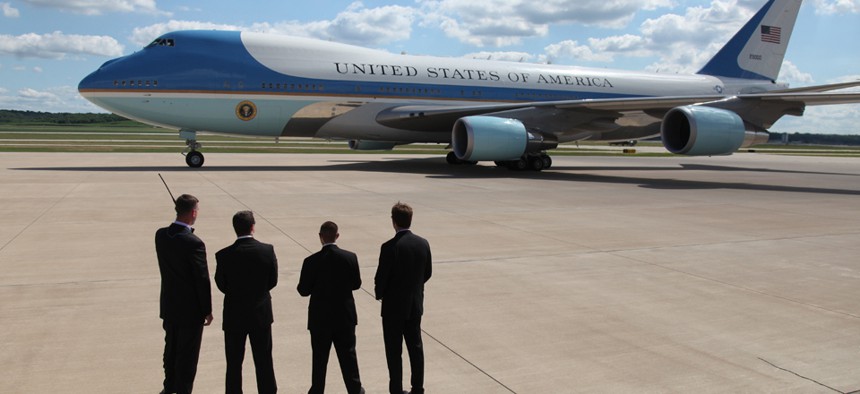 Secret Service agents watch as President Barack Obama leaves on Air Force One in 2013.