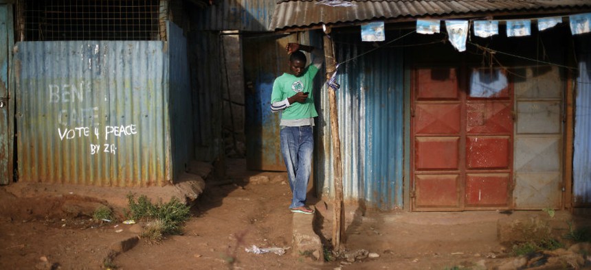A man checks his phone in Nairobi, Kenya.
