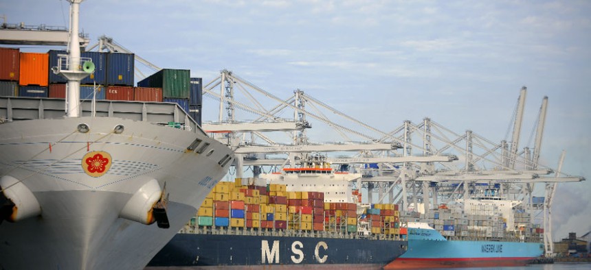 Numerous cranes work three vessels loading and unloading shipping containers at the Georgia Ports Authority Garden City terminal in Savannah, Ga.