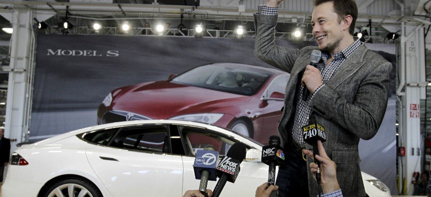 Tesla CEO Elon Musk waves during a rally at the Tesla factory in Fremont, Calif.