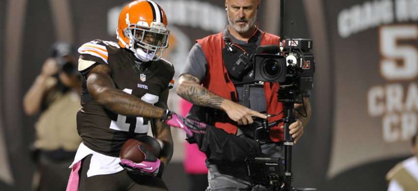 Cleveland Browns wide receiver Josh Gordon (12) celebrates beside a television cameraman during an NFL football game against the Buffalo Bills.