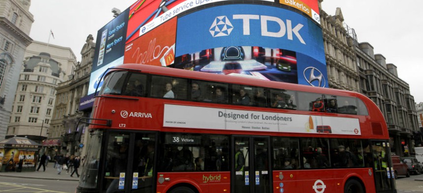 A double decker bus passes Piccadilly Circus in London. 