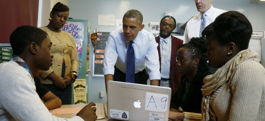 President Barack Obama, accompanied by Education Secretary Arne Duncan, right, visits a math classroom at Pathways in Technology Early College High School (P-TECH) in Brooklyn, New York.
