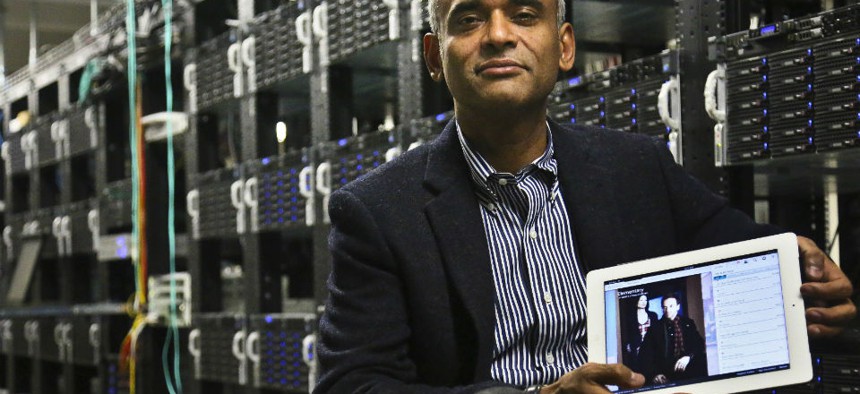 Chet Kanojia, founder and CEO of Aereo, Inc., poses with a tablet displaying his company's technology.