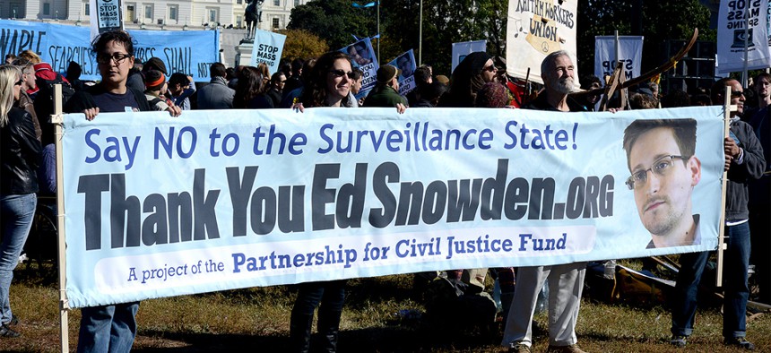 Protestors hold up a sign supporting Edward Snowden at an October rally in DC.