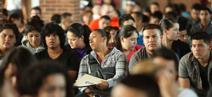 Undocumented people wait to fill out application forms for the Obama administration's Deferred Action for Childhood Arrivals program.