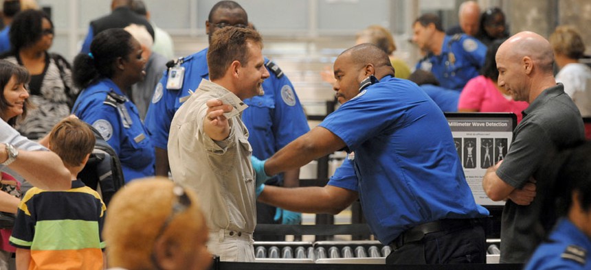 Airline passengers go through the Transportation Security Administration security checkpoint at Hartsfield-Jackson Atlanta International Airport.
