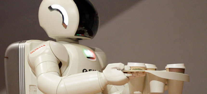 Honda Motors' humanoid robot ASIMO carries coffee. 
