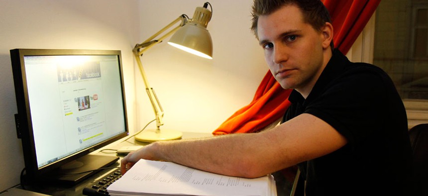 Austrian student Max Schrems sits with files about his activities on his Facebook account that Facebook handed over to him, in Vienna, Austria. 