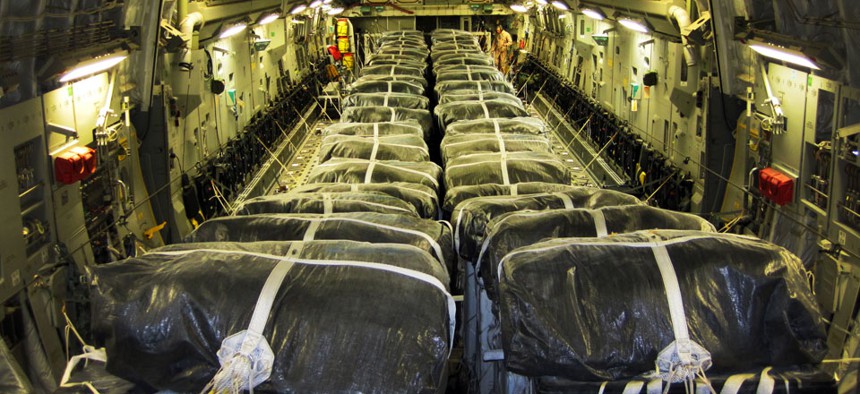 Pallets of bottled water are loaded aboard a U.S. Air Force C-17 Globemaster III aircraft in preparation for a humanitarian airdrop over Iraq Aug. 8, 2014.