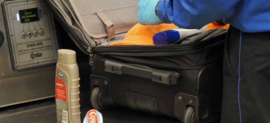 A Transportation Security Administration officer discovers unallowable liquids in a passenger's carry on luggage at the security checkpoint at Hartsfield-Jackson Atlanta International Airport.