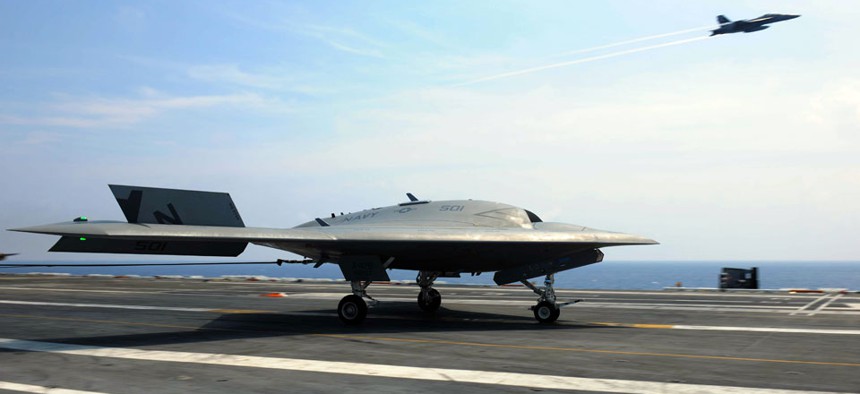The Navy's unmanned X-47B lands aboard the aircraft carrier USS Theodore Roosevelt.