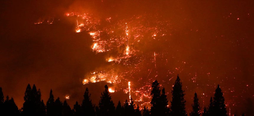 A forest smolders as the Rim Fire continues to burn near Yosemite National Park, Calif.