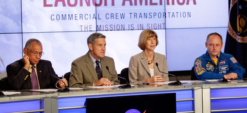 From left, NASA Administrator Charles Bolden, Kennedy Space Center Director Bob Cabana, Commercial Crew Program Manager Kathy Lueders and Astronaut Mike Fincke, announce NASA's choice of Boeing and SpaceX to ferry astronauts to the ISS.
