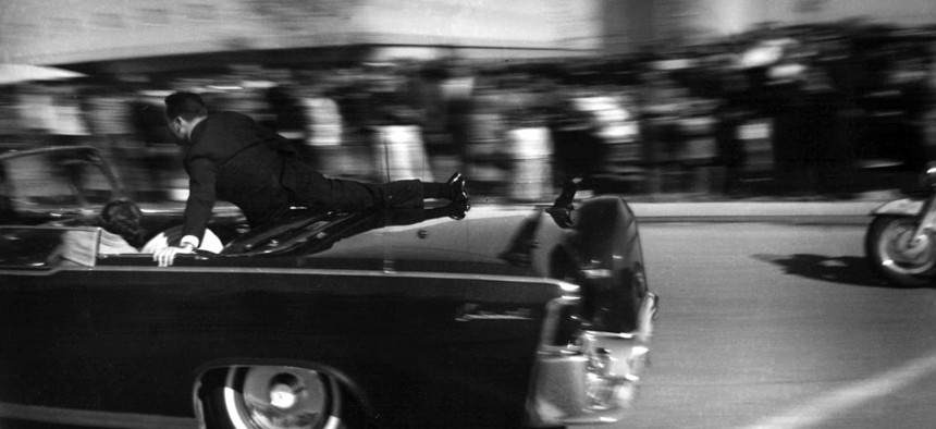 The limousine carrying mortally wounded President John F. Kennedy races toward the hospital seconds after he was shot in Dallas, on Nov. 22, 1963.