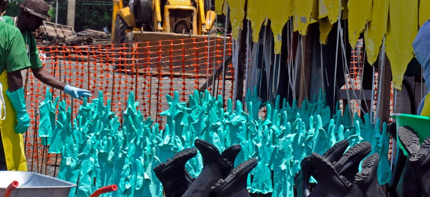 Gloves and rubber boots forming part of the Ebola prevention gear for health workers at a clinic are set outside for the sun to dry them after being washed in Monrovia, Liberia.