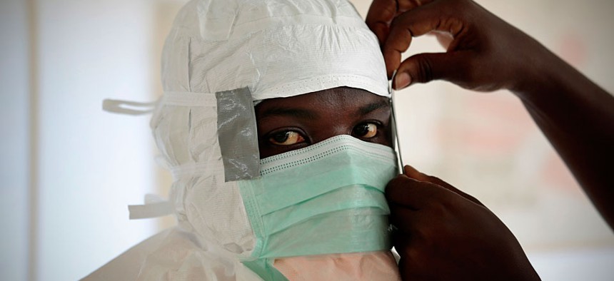 An MSF (Medecins Sans Frontieres) nurse gets prepared with Personal Protection Equipment before entering a high risk zone of MSF's Ebola isolation and treatment centre in Monrovia, Liberia.