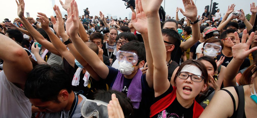 Pro-democracy student protesters confront police outside of the Chief Executive office in the government complex in Hong Kong.