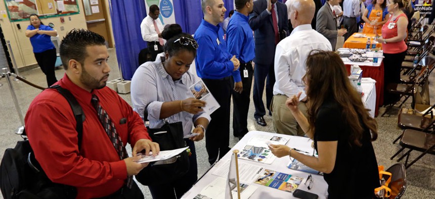 Job seekers check out the job opportunities at a Hiring Fair For Veterans in Fort Lauderdale, Fla.