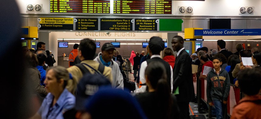 Passengers mingle in the arrivals area at John F. Kennedy International Airport in New York, Saturday, Oct. 11, 2014. Health screening procedures were put in place at the airport today to check the health of people arriving Ebola affected countries. 