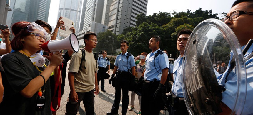 Protesters speak to the police officers in the main roads in Central district in Hong Kong Tuesday, Oct. 14, 2014.