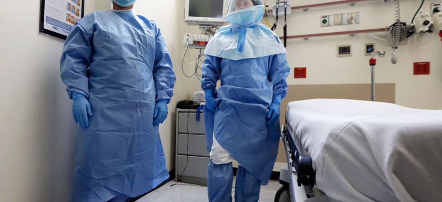 Bellevue Hospital nurse Belkys Fortune, left, and Teressa Celia, Associate Director of Infection Prevention and Control, pose in protective suits in the Emergency Room, during a demonstration of procedures for possible Ebola patients.