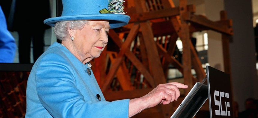 Queen Elizabeth II sends her first Tweet during a visit to the Information Age Exhibition at the London Science Museum.