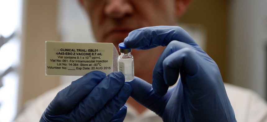 Professor Adrian Hill, Director leader of the trials for the experimental Ebola vaccine holds a vial of the vaccine in Oxford, England Wednesday Sept. 17, 2014.