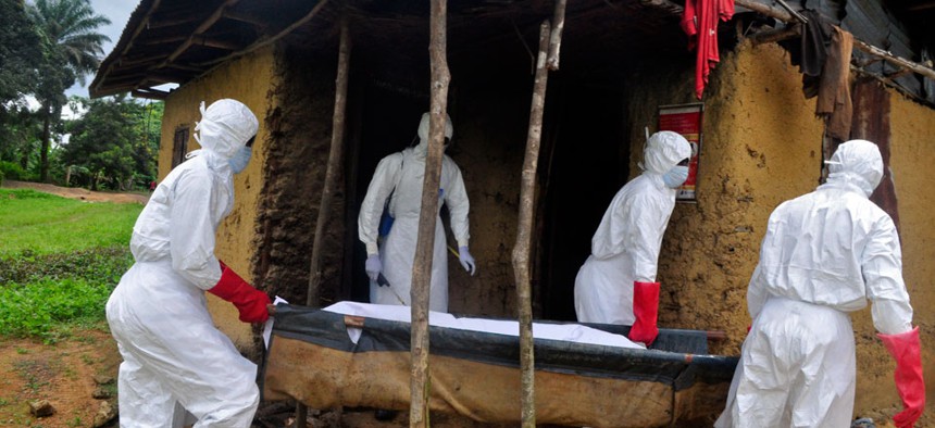 Health workers carry the body of a old man from his house as he is suspected of dying from the Ebola virus in the Siah Town area on the outskirts of Monrovia, Liberia.