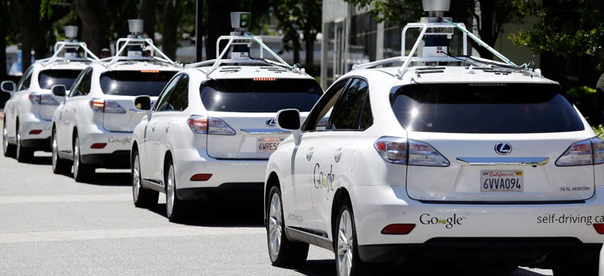 A row of Google self-driving cars are shown outside the Computer History Museum in Mountain View, Calif.