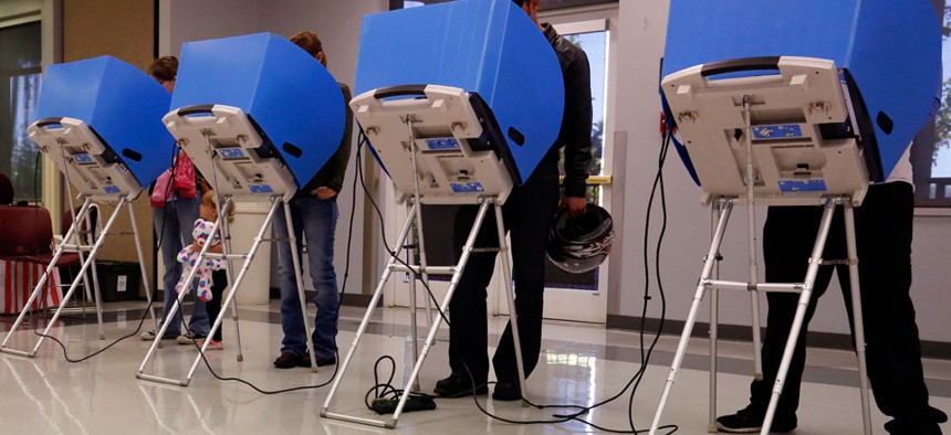 Adams County, Colorado voters casts their vote at a polling place in the Thornton Recreation Center, Tuesday, Nov. 4, 2014.