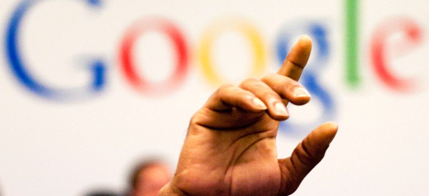 a man raises his hand during a meeting at Google offices, Oct. 17, 2012.
