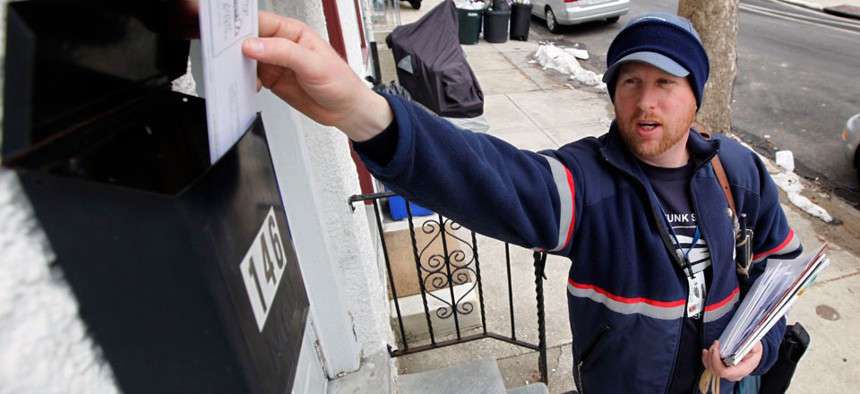Letter carrier Kevin Pownall delivers mail in Philadelphia. 