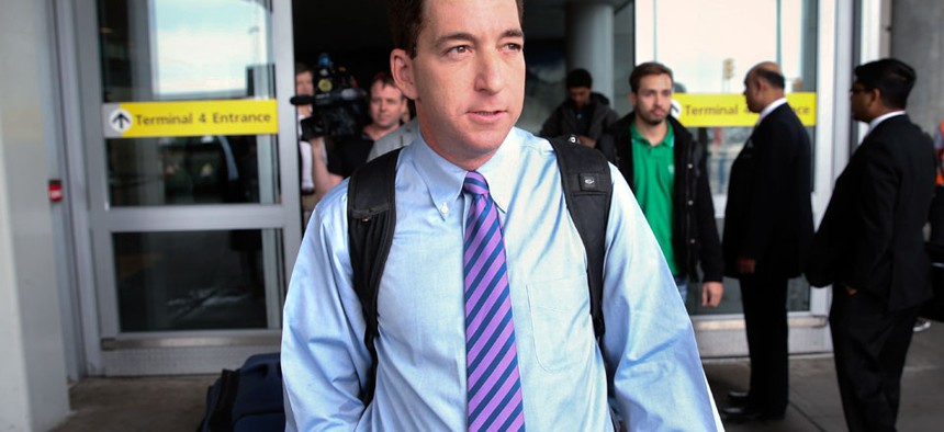 Journalist Glenn Greenwald steps out of Terminal 4 after arriving at John F. Kennedy International Airport Friday, April 11, 2014, in New York. 
