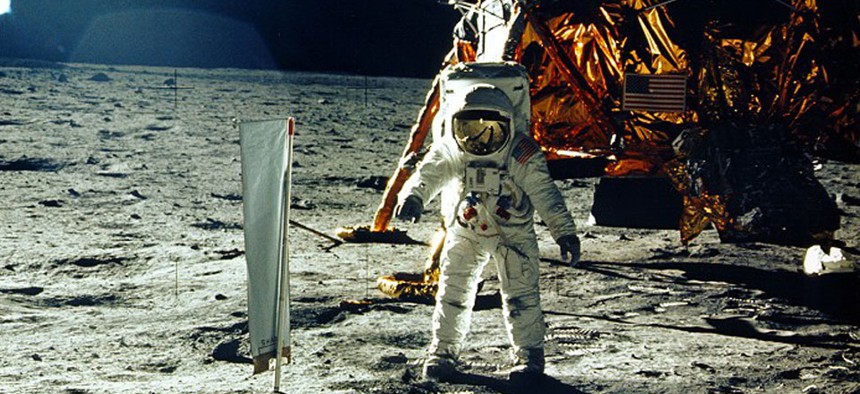 NASA astronaut Buzz Aldrin stands beside solar wind experiment on the moon.