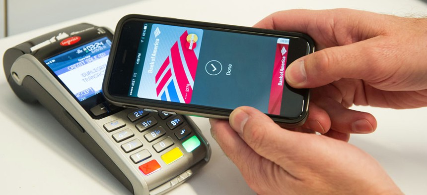 MasterCard demonstrates Apple Pay at the launch of MasterCard's NYC Tech Hub on Monday, Oct. 20, 2014.