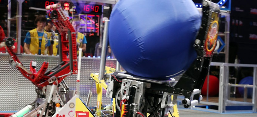 Robots compete at the FIRST robotics competition.