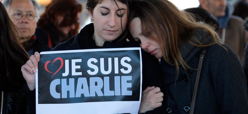 People pay tribute to the victims of the satirical newspaper "Charlie Hebdo", in Marseille, southern France, Thursday, Jan. 8, 2015.