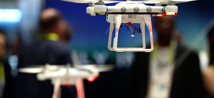 Drones fly at the Autel booth during the International CES Wednesday, Jan. 7, 2015.