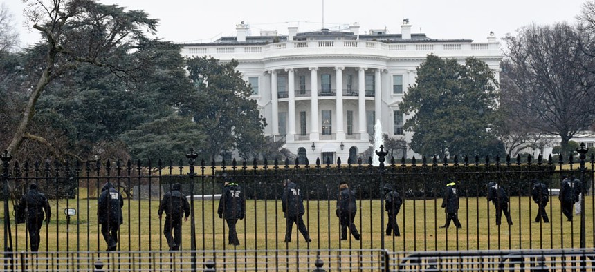 Secret Service officers search the south grounds of the White House after a  device, possibly an unmanned aerial drone, was found on the White House grounds. 