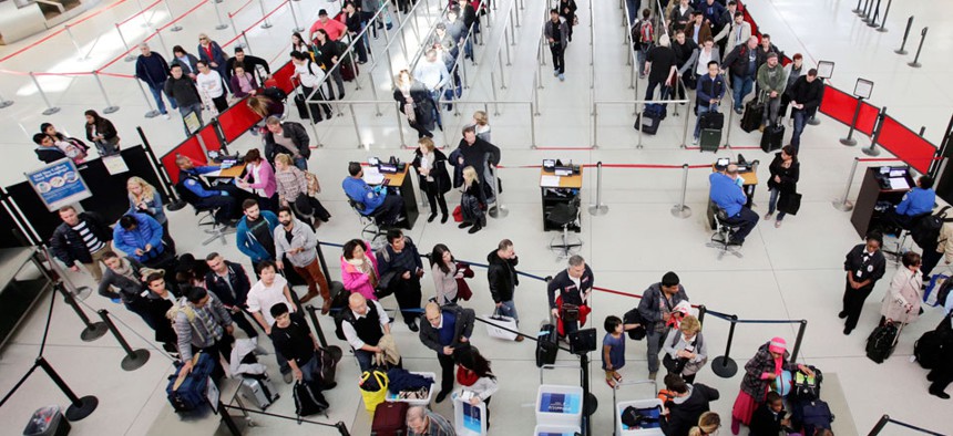 Passengers line up to pass through the TSA security before boarding flights at John F. Kennedy International Airport.