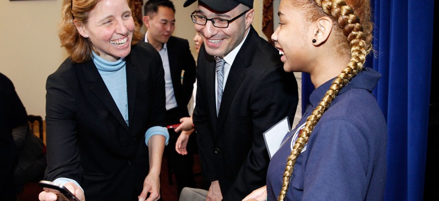 CTO Megan Smith shares a laugh with a middle school student from Newark, N.J. and Code.org Founder Hadi Partovi, center, after teaching U.S. President Barack Obama how to code at the White House.