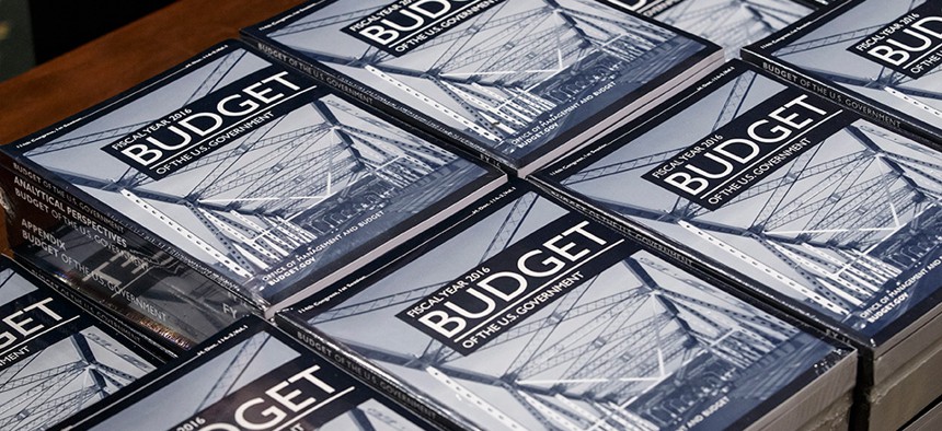 President Barack Obama's new $4 trillion budget plan is distributed by Senate Budget Committee staffer Eric Chalmers as it arrives on Capitol Hill in Washington, early Monday, Feb. 2, 2015. 