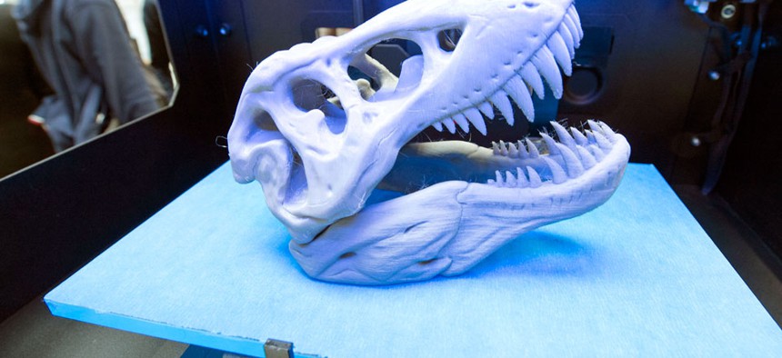 A 3D print of a dinosaur's head lies in a printer of the US company MakerBot of New York.