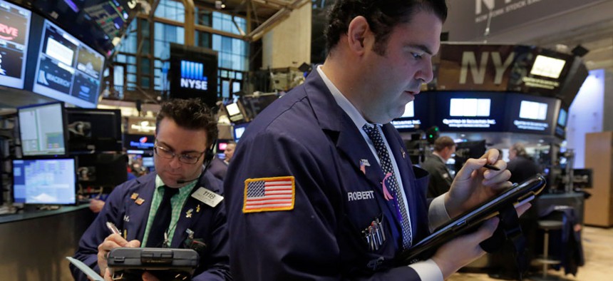 Trader Robert McQuade, right, works on the floor of the New York Stock Exchange, Thursday, March 5, 2015.