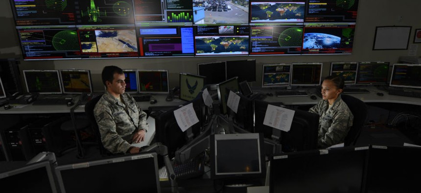 Two airmen in the Global Strategic Warning and Space Surveillance System Center at Cheyenne Mountain Air Force Station, Colo., on Sept. 2, 2014. 